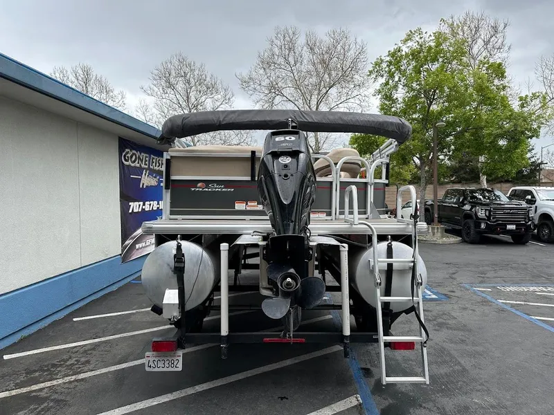 Slide: The Image of 2019 Sun Tracker Party Barge 18 DLX pontoon boat in parking lot, rear view. - 5
