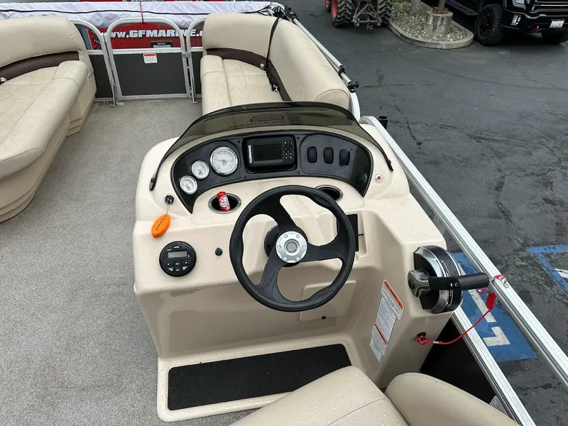 Slide: The Image of 2019 Sun Tracker Party Barge 18 DLX boat interior with steering console and seating. - 9
