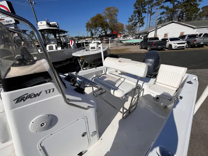 Slide: The Image of 2010 Sea Hunt Triton 177 boat with seating and console, parked outdoors. - 12