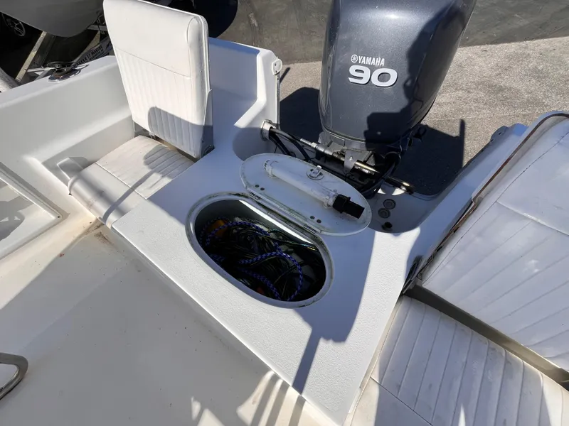 Slide: The Image of 2010 Sea Hunt Triton 177 boat with Yamaha 90 engine, open storage compartment. - 14