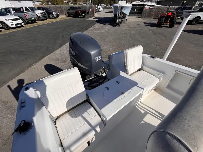 Slide: The Image of 2010 Sea Hunt Triton 177 boat with Yamaha 90 engine, parked in a lot. - 6