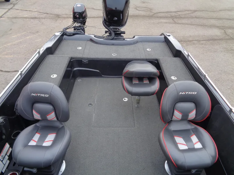 Slide: The Image of 2018 Nitro ZV21 boat interior with three cushioned seats and motor. - 11