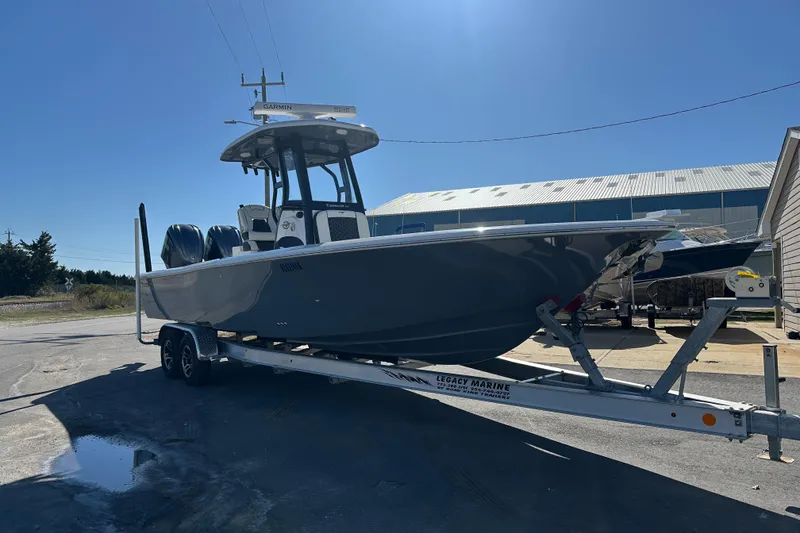 Slide: The Image of 2023 Tidewater 2700 Carolina Bay boat on trailer under clear blue sky. - 10