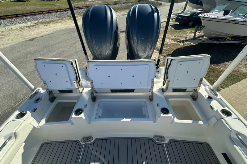 Slide: The Image of 2023 Tidewater 2700 Carolina Bay boat with dual engines and open storage compartments. - 13