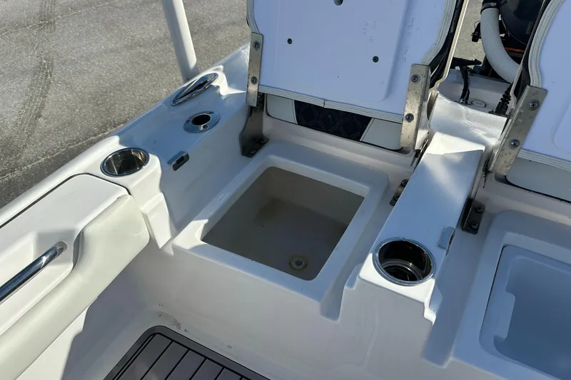 Slide: The Image of 2023 Tidewater 2700 Carolina Bay boat interior with storage compartments and cup holders. - 15