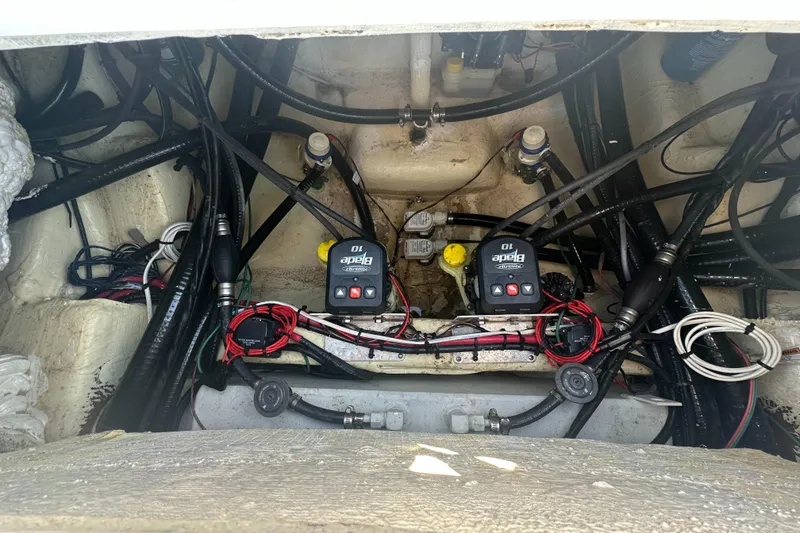 Slide: The Image of Engine compartment of 2023 Tidewater 2700 Carolina Bay boat, showcasing wiring and components. - 16