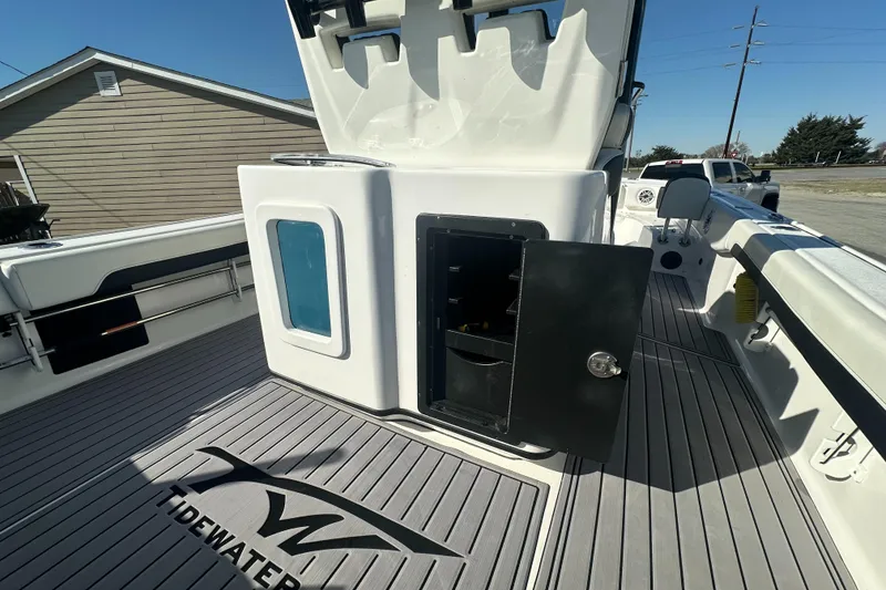 Slide: The Image of 2023 Tidewater 2700 Carolina Bay boat interior with storage compartments open. - 18