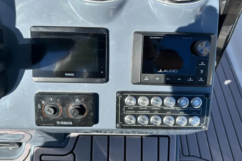 Slide: The Image of Control panel of 2023 Tidewater 2700 Carolina Bay with Yamaha and JL Audio systems. - 24