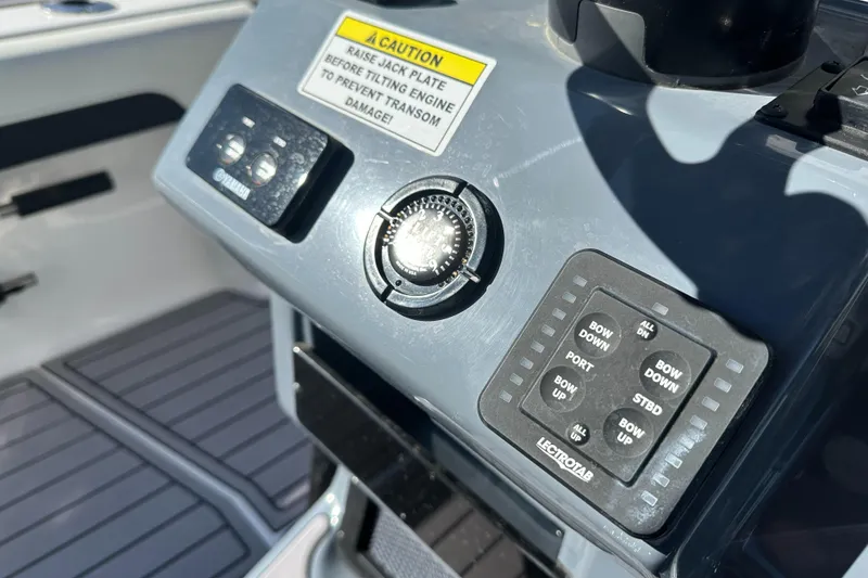 Slide: The Image of Control panel of 2023 Tidewater 2700 Carolina Bay boat with caution label and buttons. - 27