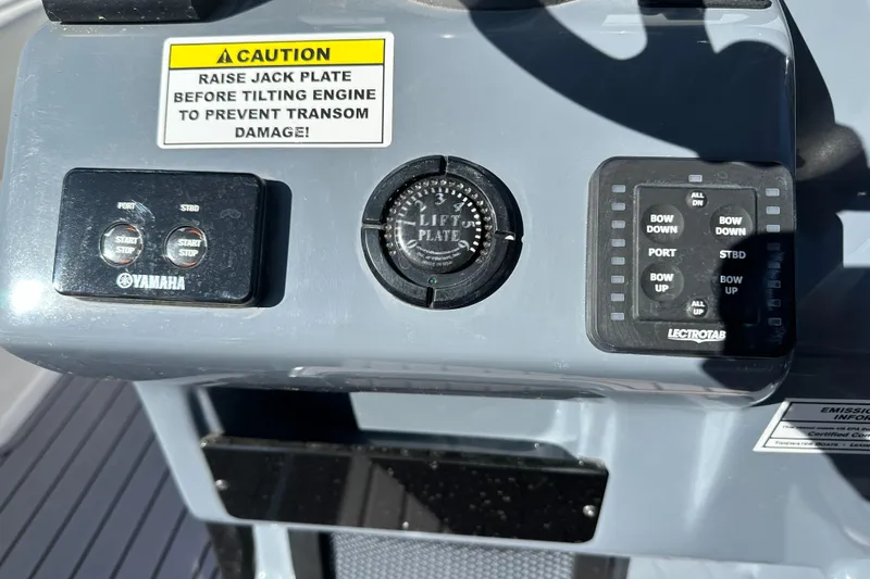 Slide: The Image of Control panel of 2023 Tidewater 2700 Carolina Bay boat with warning label and switches. - 28