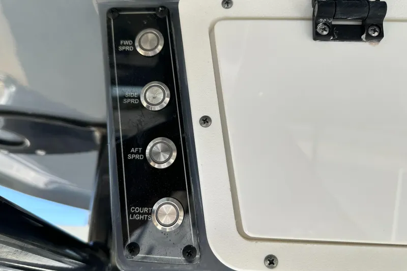 Slide: The Image of Control panel of 2023 Tidewater 2700 Carolina Bay boat with light switches. - 33