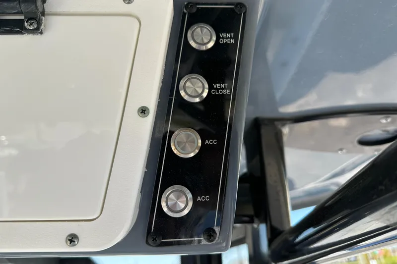 Slide: The Image of Control panel of 2023 Tidewater 2700 Carolina Bay boat with vent and accessory buttons. - 34