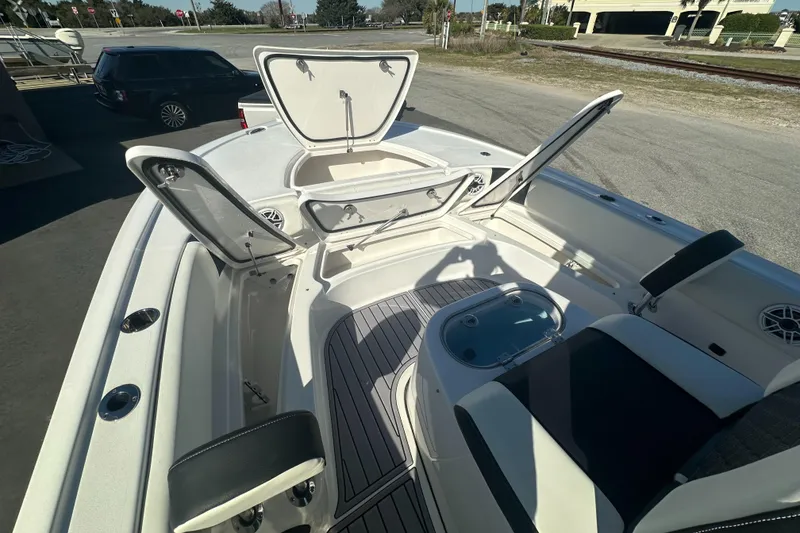 Slide: The Image of 2023 Tidewater 2700 Carolina Bay boat with open storage compartments and seating area. - 37