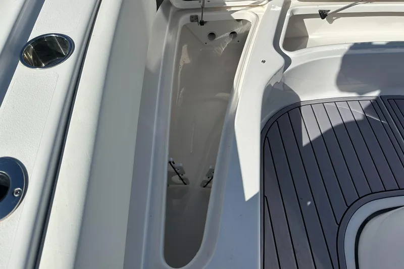 Slide: The Image of 2023 Tidewater 2700 Carolina Bay boat interior with storage compartment and sleek deck design. - 38