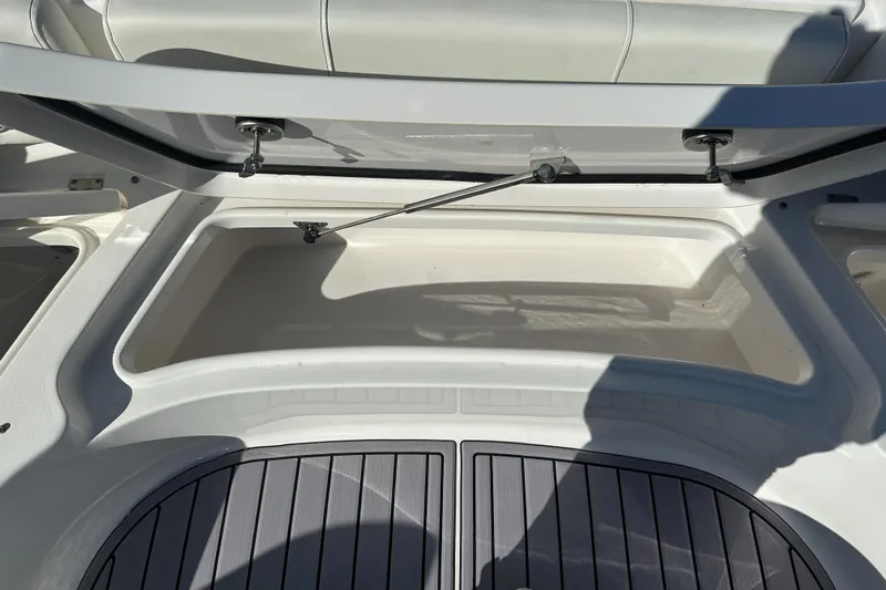 Slide: The Image of 2023 Tidewater 2700 Carolina Bay boat storage compartment with open lid. - 39