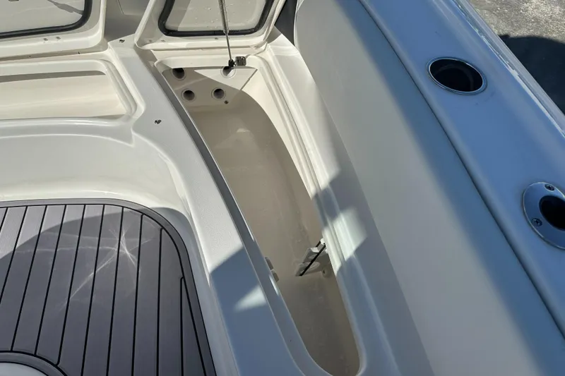 Slide: The Image of 2023 Tidewater 2700 Carolina Bay boat interior with storage compartments and rod holders. - 41
