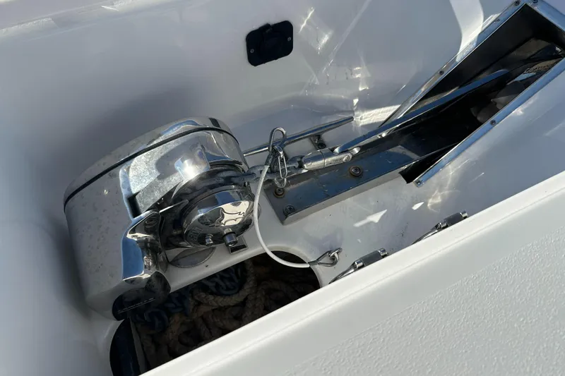 Slide: The Image of 2023 Tidewater 2700 Carolina Bay boat anchor compartment with winch and rope. - 42