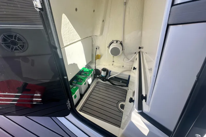 Slide: The Image of 2023 Tidewater 2700 Carolina Bay boat interior with storage and battery compartment. - 49