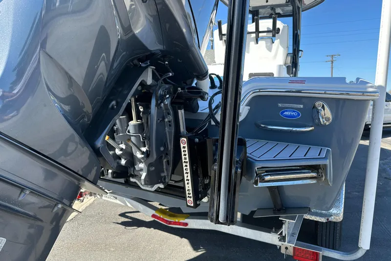 Slide: The Image of 2023 Tidewater 2700 Carolina Bay boat rear view with engine and trailer. - 6