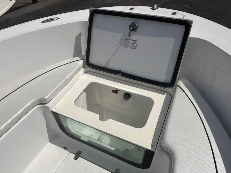 Slide: The Image of 2022 Wellcraft 202 Fisherman boat with open storage compartment in white interior. - 12