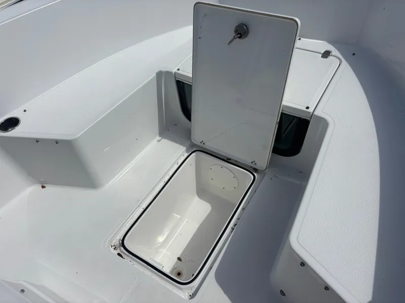 Slide: The Image of 2022 Wellcraft 202 Fisherman boat storage compartment with open hatch. - 15