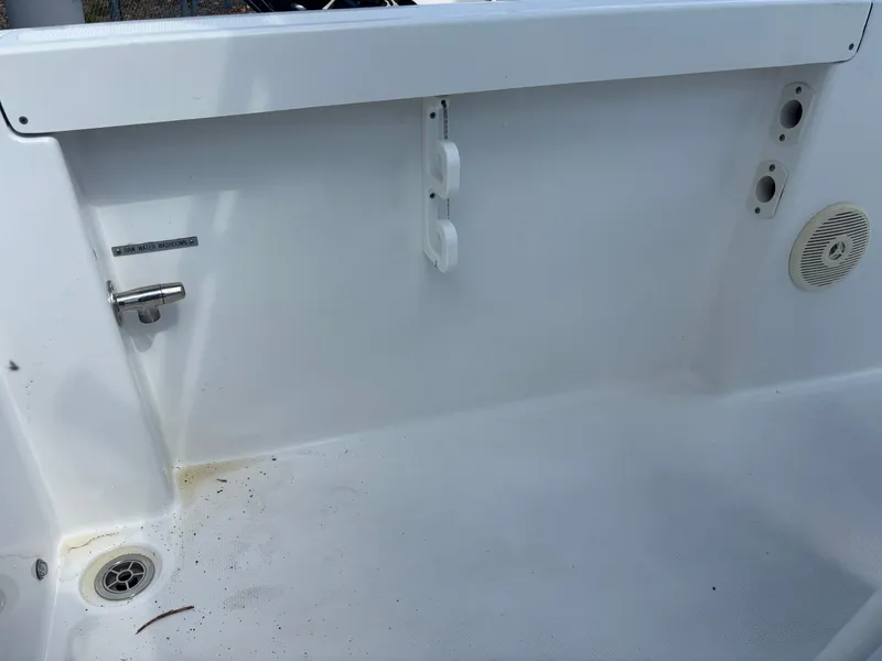 Slide: The Image of 2022 Wellcraft 202 Fisherman boat interior, featuring clean white deck and drainage system. - 17