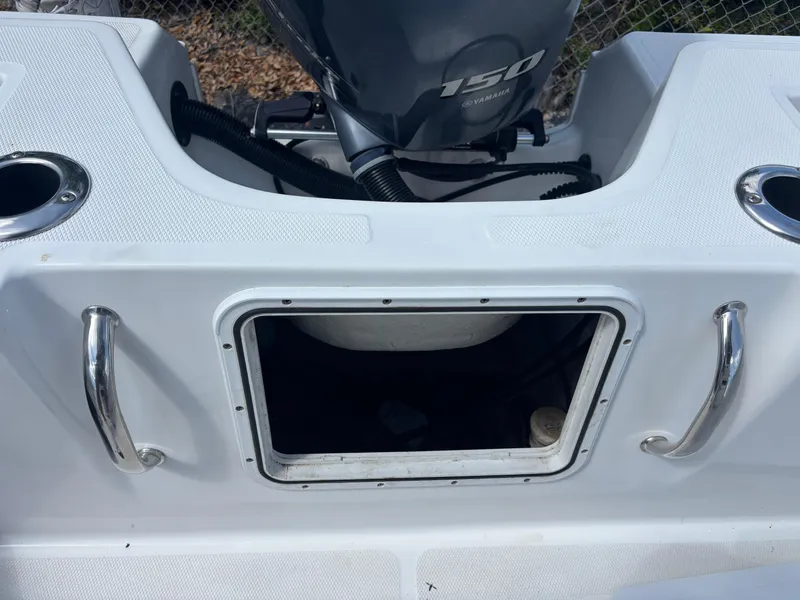 Slide: The Image of 2022 Wellcraft 202 Fisherman boat with open storage compartment and Yamaha 150 engine. - 18