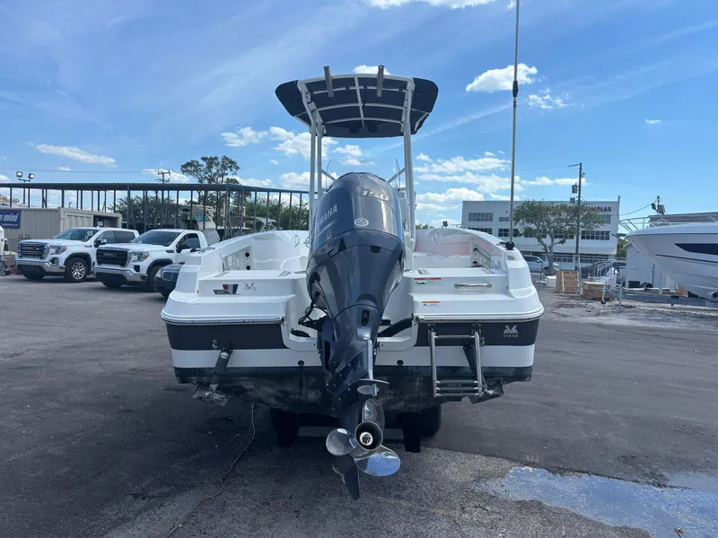 Slide: The Image of 2022 Wellcraft 202 Fisherman boat with outboard motor, parked on a lot under a blue sky. - 3