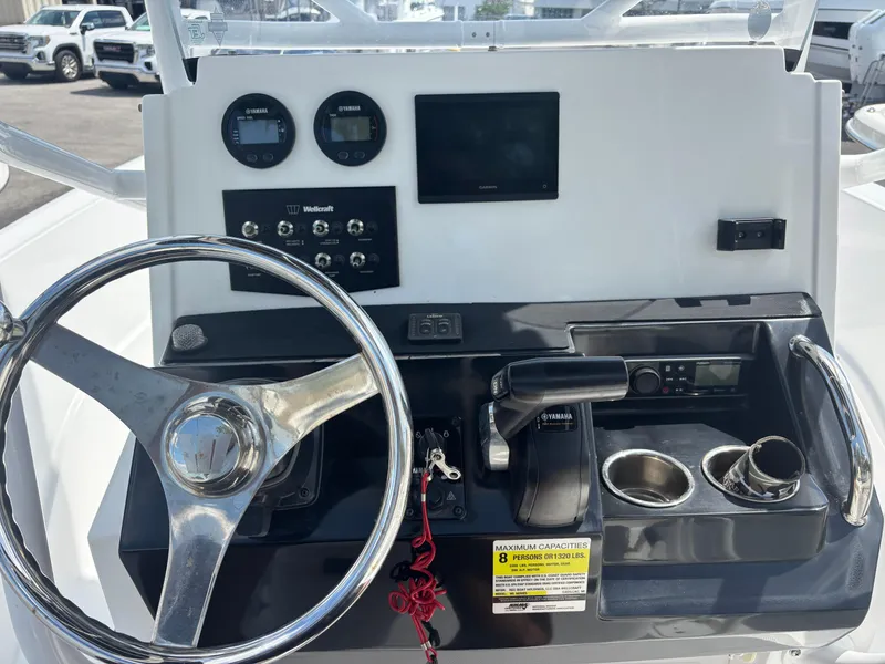 Slide: The Image of Control panel of a 2022 Wellcraft 202 Fisherman boat with steering wheel and gauges. - 4
