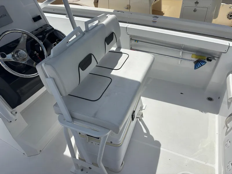 Slide: The Image of 2022 Wellcraft 202 Fisherman boat interior with white seating and steering console. - 6