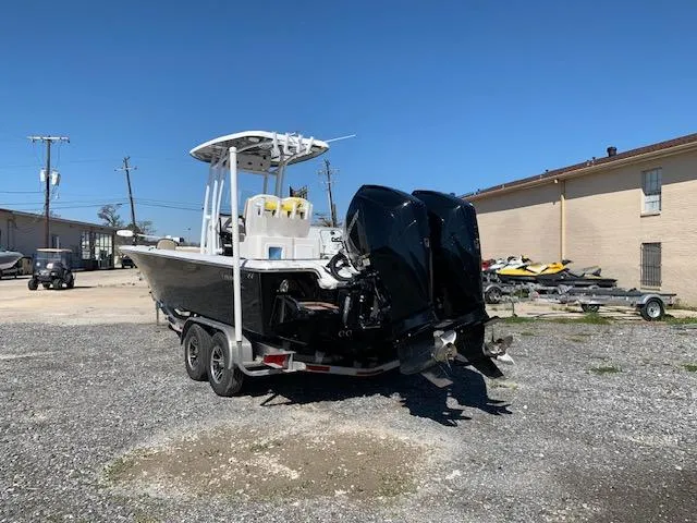 Slide: The Image of 2019 Tidewater 2700 Carolina Custom Bay boat on trailer, dual engines, outdoor setting. - 4