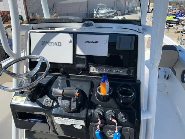 Slide: The Image of 2019 Tidewater 2700 Carolina Custom Bay boat dashboard with Simrad and Mercury controls. - 7