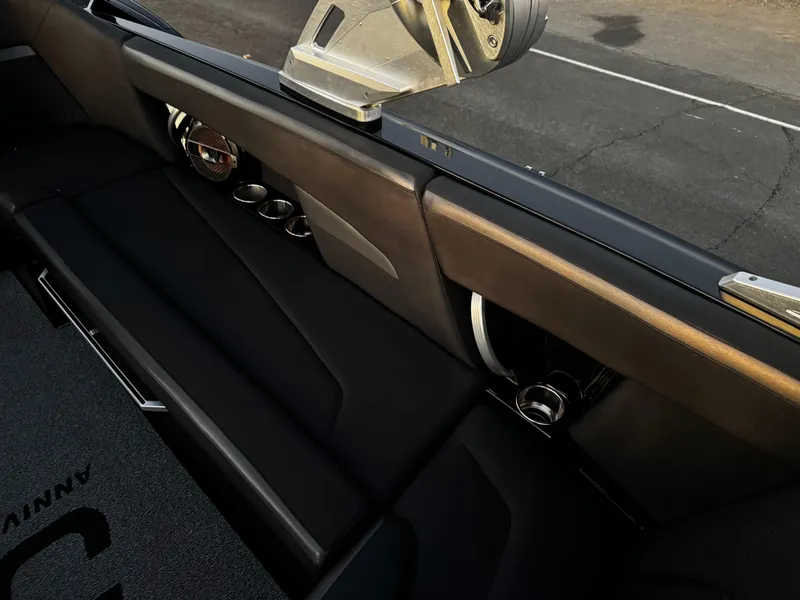 Slide: The Image of 2018 MasterCraft XStar interior with sleek black seating and modern speaker system. - 10