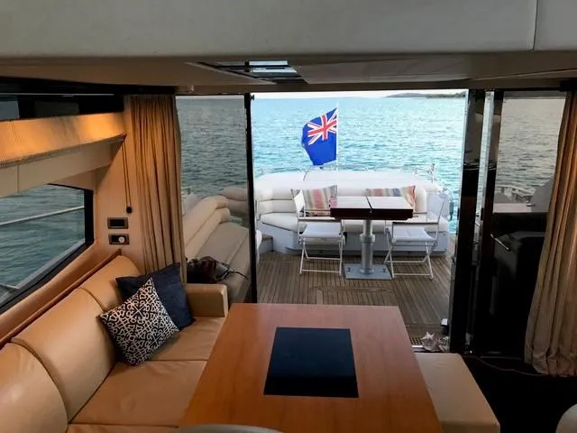Slide: The Image of Luxurious interior of 2011 Sunseeker 64 Predator yacht with ocean view and outdoor seating. - 11
