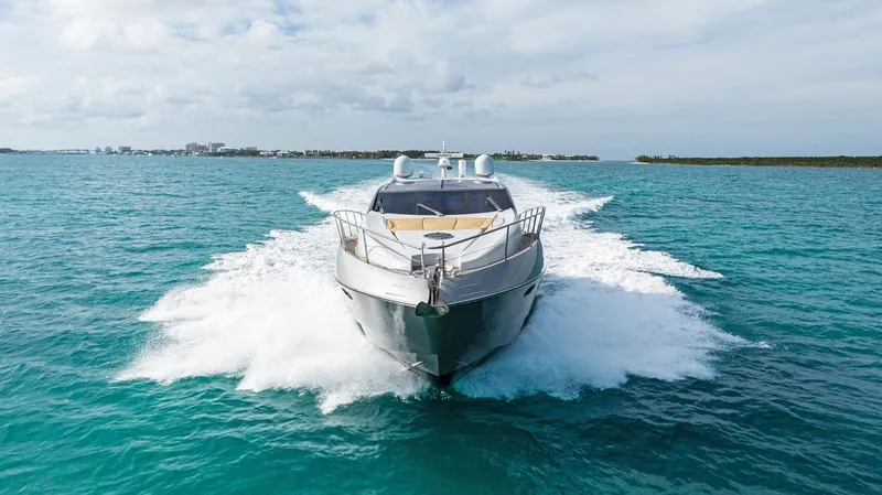 Slide: The Image of Sunseeker 64 Predator 2011 yacht cruising on turquoise waters under a cloudy sky. - 3