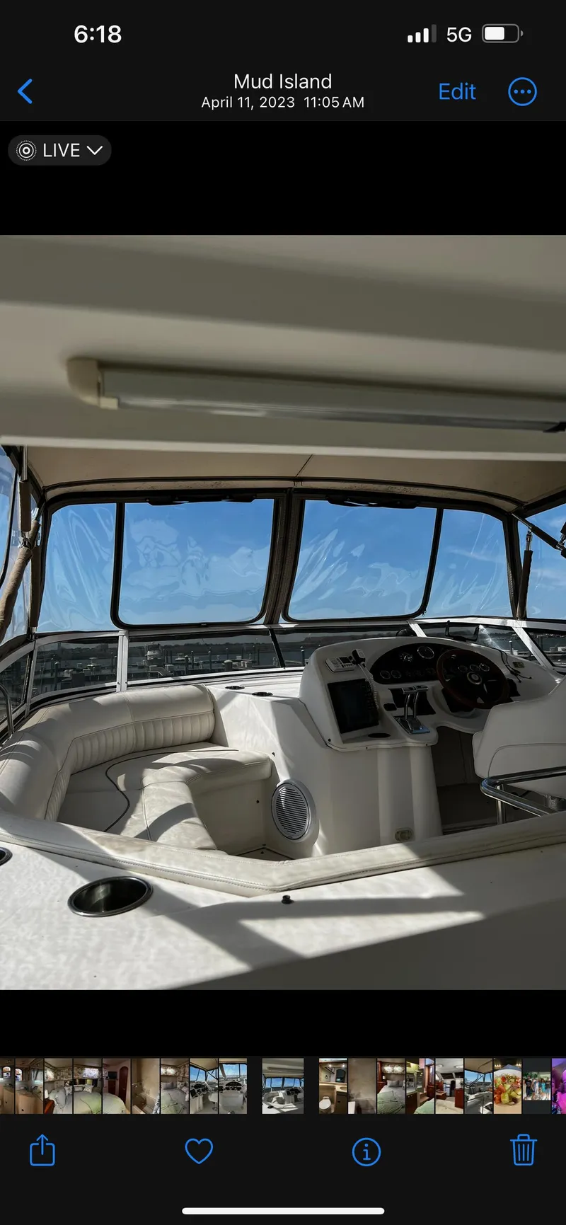 Slide: The Image of 1999 Cruisers aft cabin boat interior with helm and seating, Mud Island backdrop. - 27