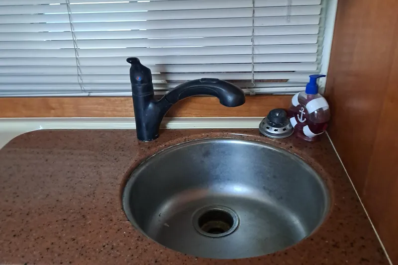 Slide: The Image of 1999 Cruisers aft cabin sink with faucet and countertop accessories. - 3