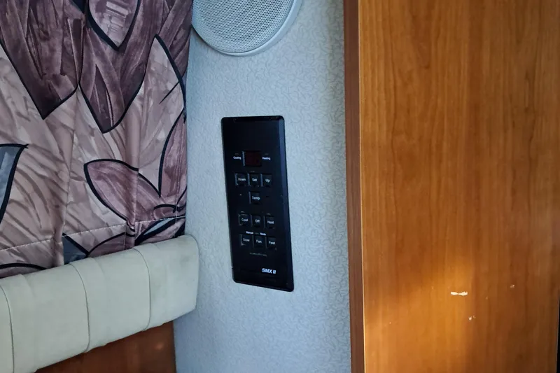 Slide: The Image of 1999 Cruisers aft cabin interior with control panel and speaker. - 5