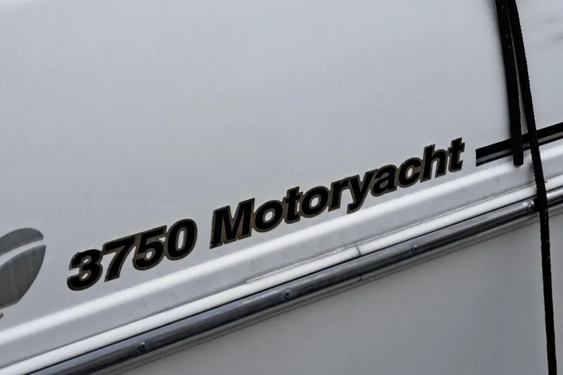 Slide: The Image of 1999 Cruisers 3750 Motoryacht aft cabin, white exterior with black lettering. - 8