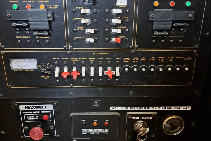 Slide: The Image of Control panel of a 1999 Cruisers aft cabin boat with switches and gauges. - 16