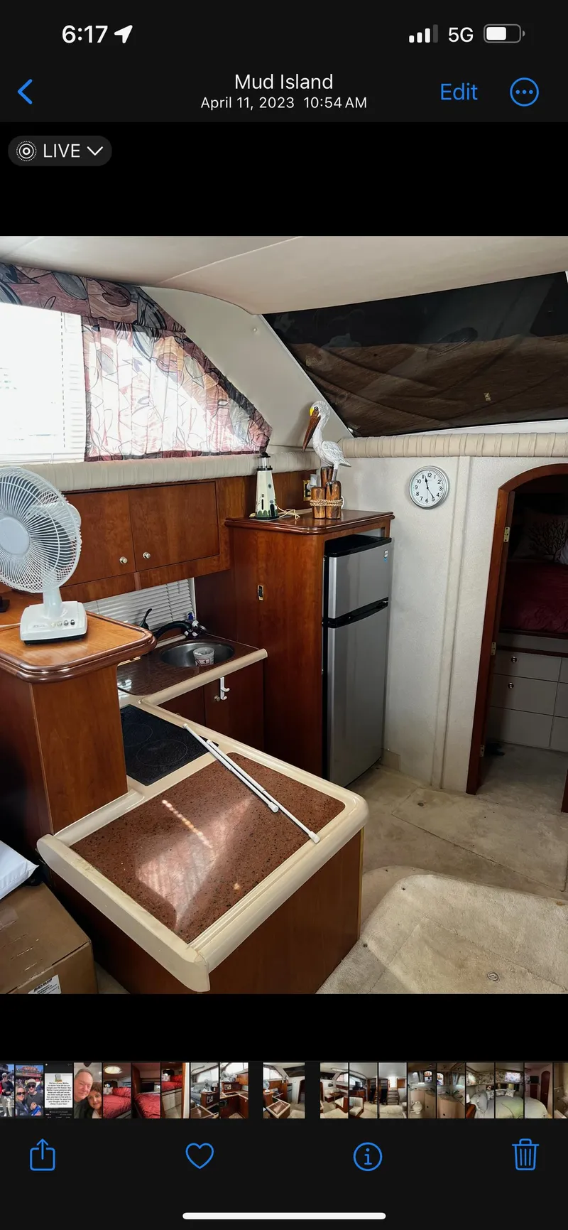 Slide: The Image of 1999 Cruisers aft cabin interior with kitchenette, fan, and mini fridge. - 21