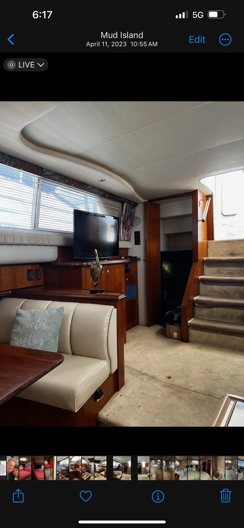 Slide: The Image of 1999 Cruisers aft cabin interior with seating, TV, and stairs, showcasing cozy marine design. - 22