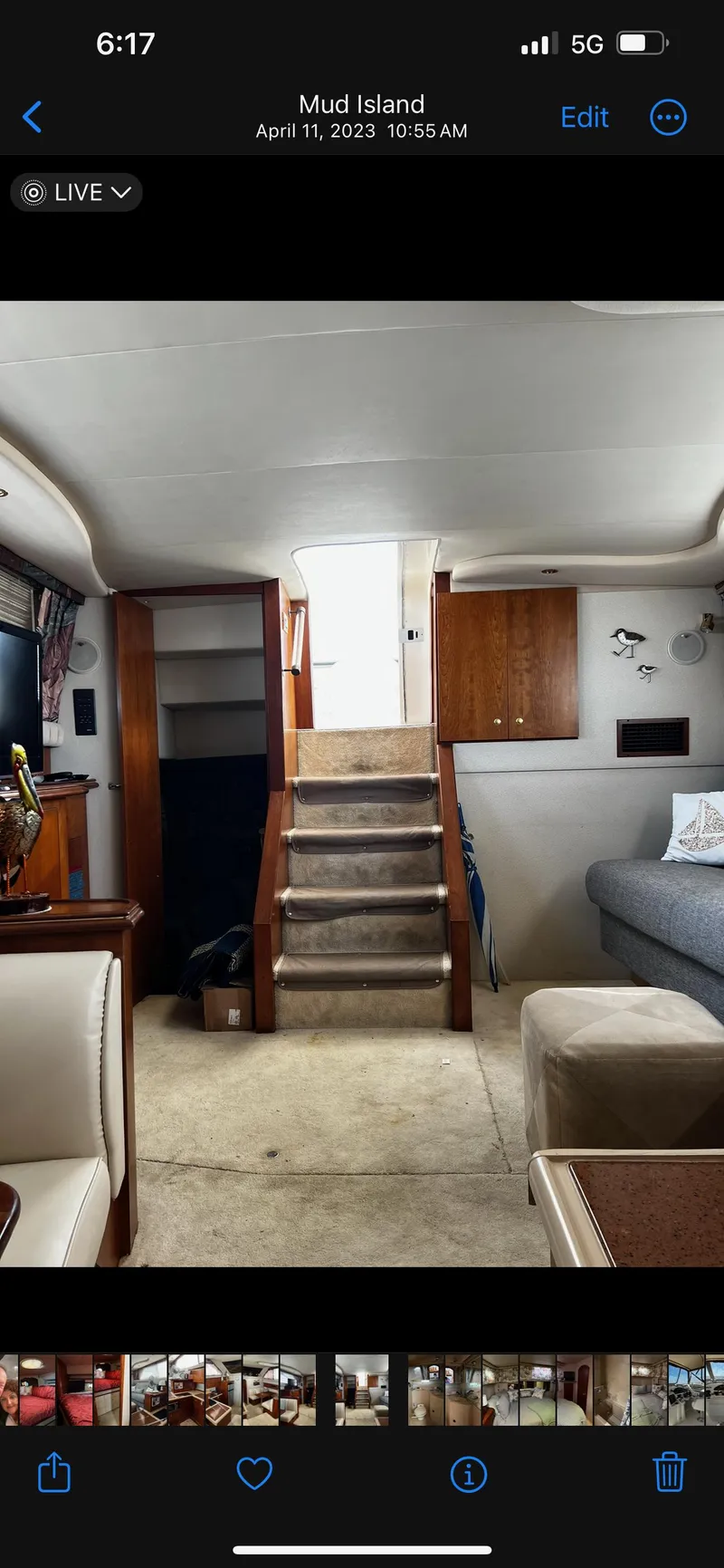 Slide: The Image of 1999 Cruisers aft cabin interior with stairs, seating, and wooden cabinetry. - 23