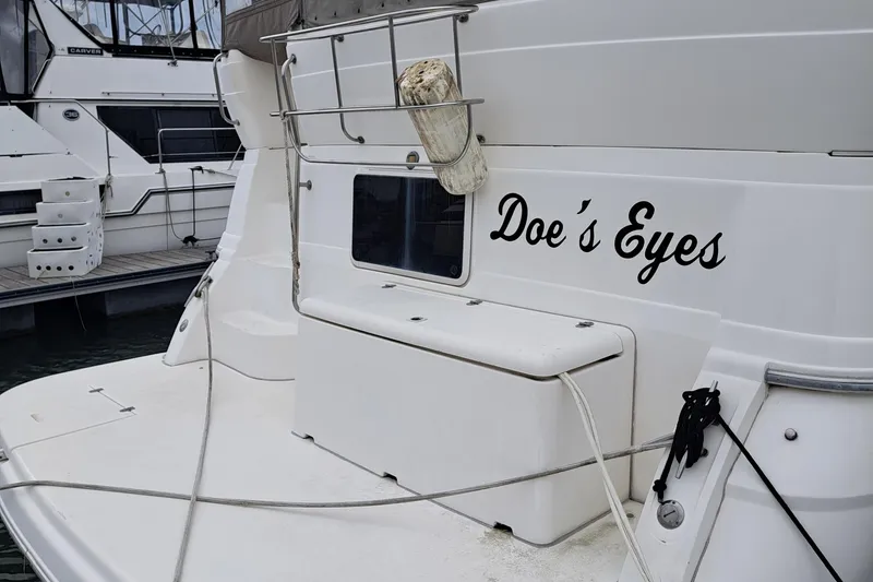 Slide: The Image of 1999 Cruisers aft cabin boat named "Doe's Eyes" docked at marina. - 7