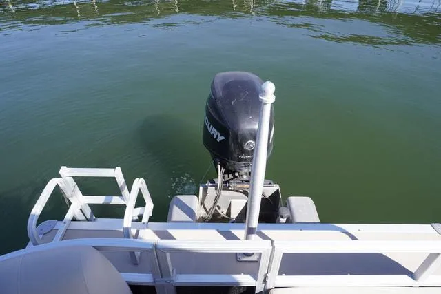 Slide: The Image of 2014 Sun Tracker Party Barge 24 XP3 with Mercury outboard motor on calm water. - 11