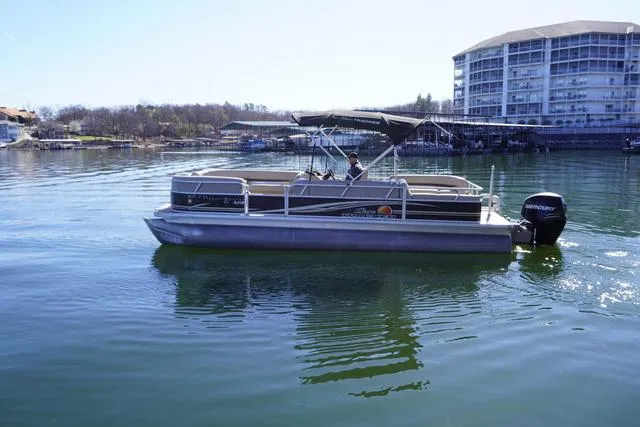 Slide: The Image of 2014 Sun Tracker Party Barge 24 XP3 pontoon boat on a calm lake near a marina. - 3