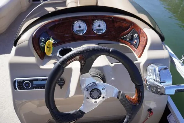 Slide: The Image of Steering console of 2014 Sun Tracker Party Barge 24 XP3 with gauges and controls. - 6