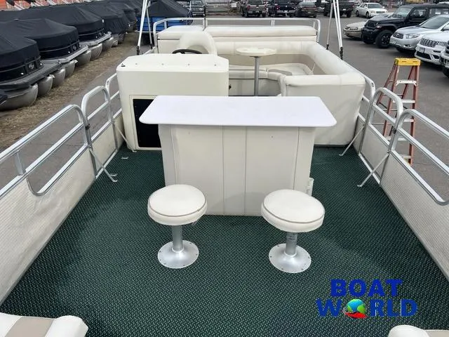 Slide: The Image of 2000 Weeres Sundeck 280 TT pontoon boat interior with bar and seating, featuring 2021 Honda 100HP engine. - 15