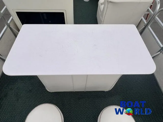 Slide: The Image of Interior view of 2000 Weeres Sundeck 280 with table and seating, featuring Boat World logo. - 17