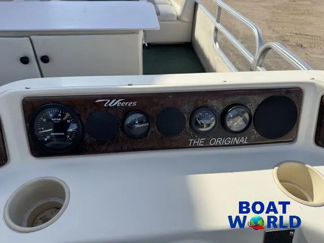 Slide: The Image of Interior of 2000 Weeres Sundeck 280 with round table and cushioned seating. - 25